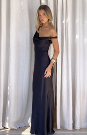 Side view of a black satin off-shoulder maxi dress with a draped cowl neck and flowing skirt