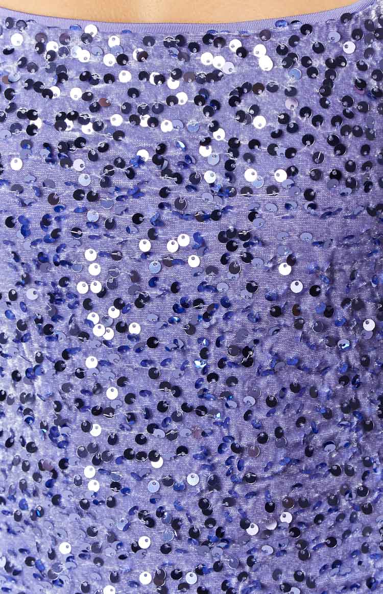 Close-up of the lilac sequin fabric with a mix of iridescent silver and dark purple sequins