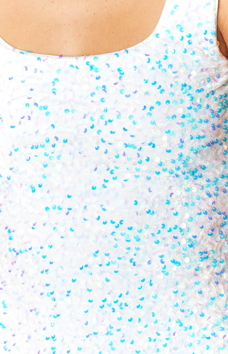Close-up of the white sequin fabric with iridescent blue and purple sequins
