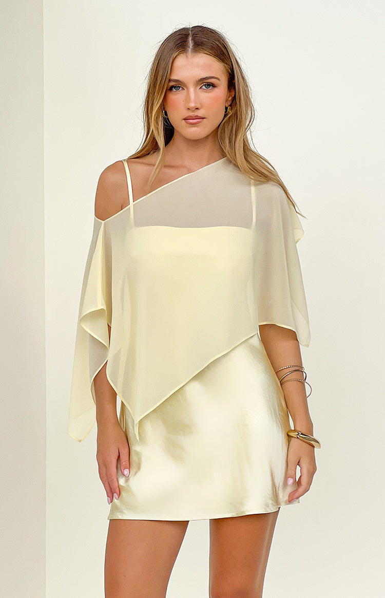 Yellow satin mini dress with a sheer asymmetric draped overlay and thin spaghetti straps