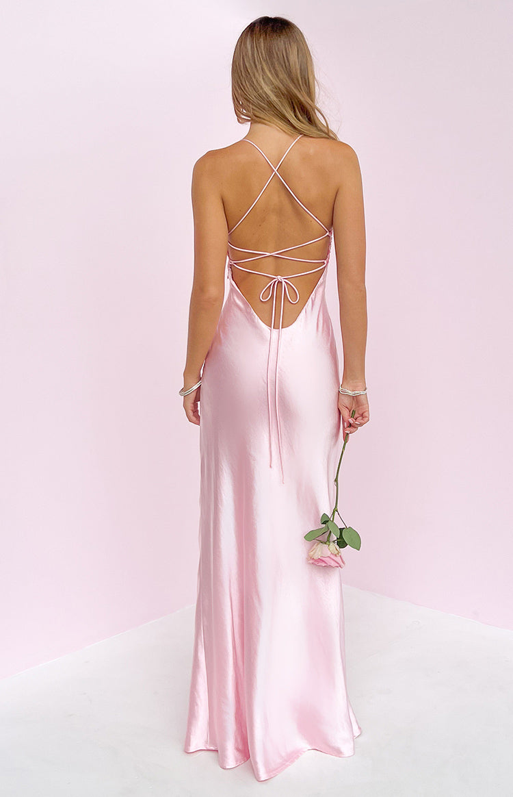 Rear view of a pink satin maxi dress with criss-cross spaghetti straps and a low scoop back with tie detail