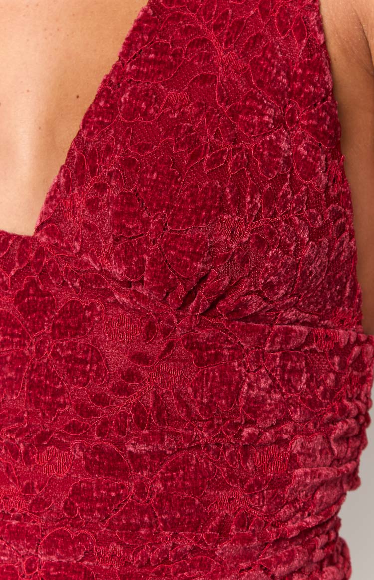 Close-up of the red velvet crop top's intricate floral lace overlay and ruched bust