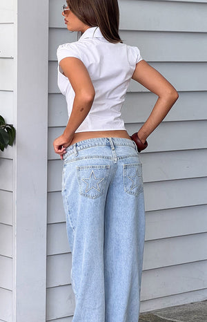 Beginning Boutique Clara Star Light Wash Denim Low Rise Jeans light wash denim low rise wide leg jeans with star embroidery on back pockets