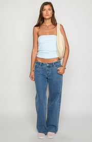 Mid wash denim low rise jeans with a relaxed wide leg fit and front button closure