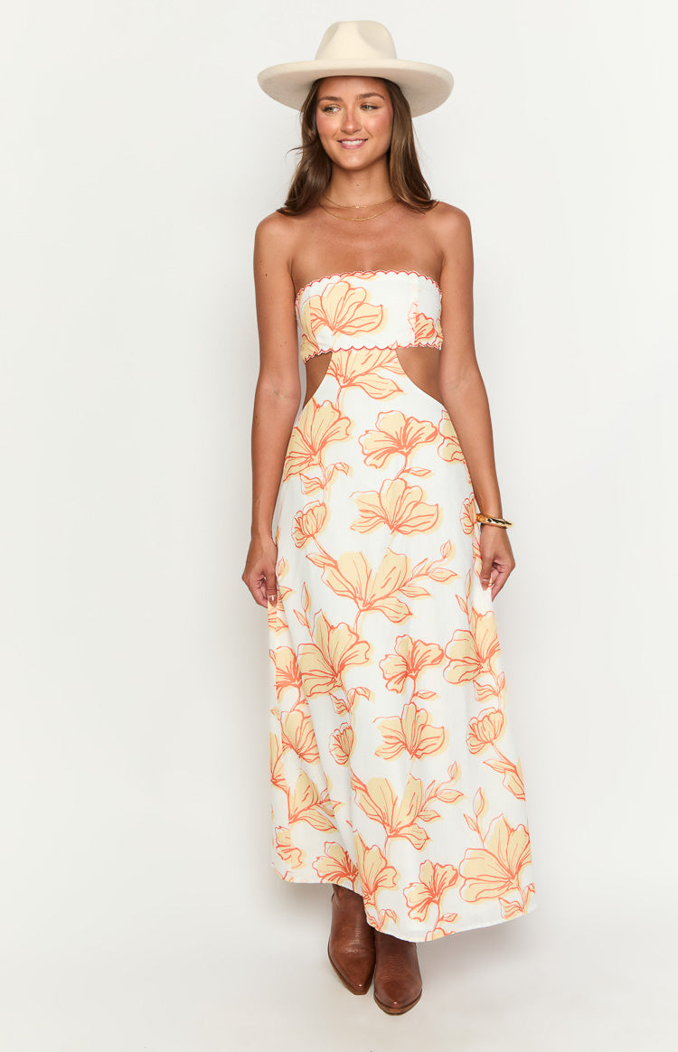 White strapless maxi dress with orange floral print, scalloped neckline, and side waist cutouts