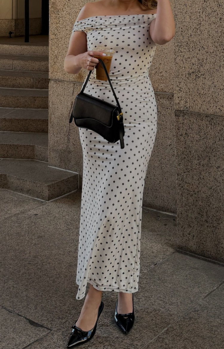 Fitted white mesh maxi dress with black polka dots and an off-shoulder neckline