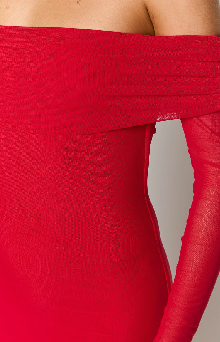 Close-up of the red off-shoulder draped neckline and sheer long sleeve of a fitted maxi dress