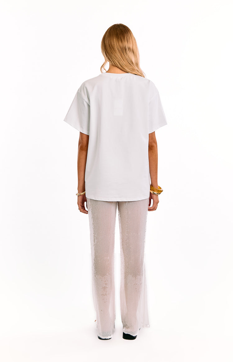 Back view of white sequin wide-leg pants, with a sheer finish and full-length wide-leg cut