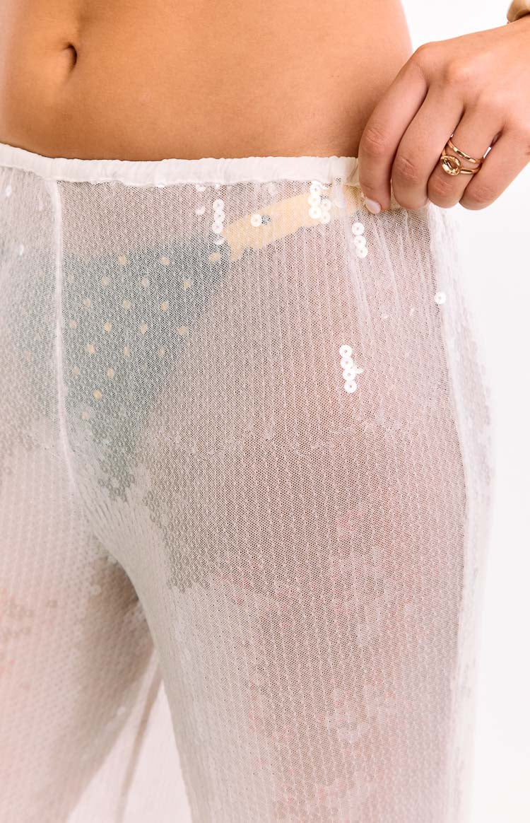 Close-up of the elasticated waistband and the sheer white sequin fabric of the wide leg pants