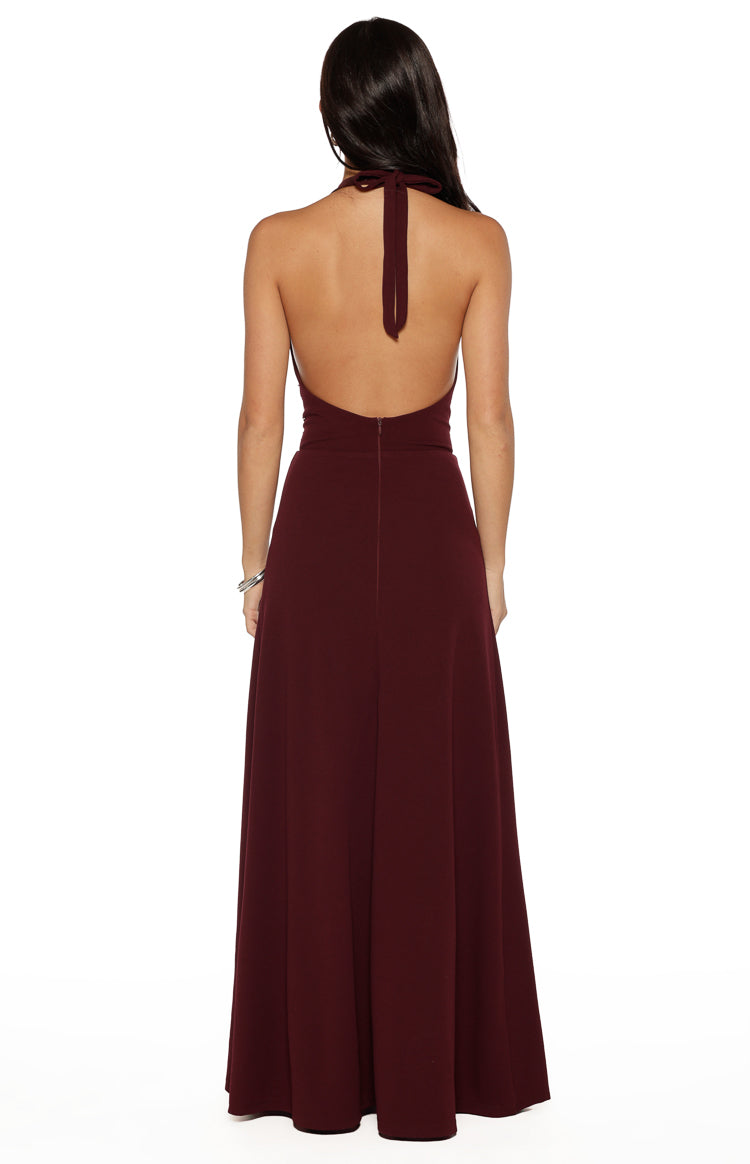 Rear view of the burgundy maxi dress with a halter neck tie, low open back, and center back zip