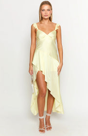 Pale yellow maxi dress with a sweetheart neckline, ruffled shoulder straps, and an asymmetrical high-low hem