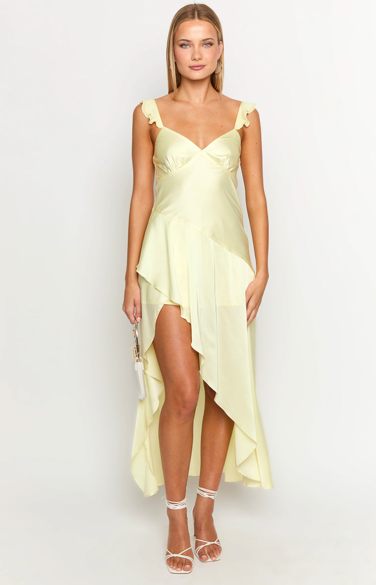 Pale yellow maxi dress with a sweetheart neckline, ruffled shoulder straps, and an asymmetrical high-low hem