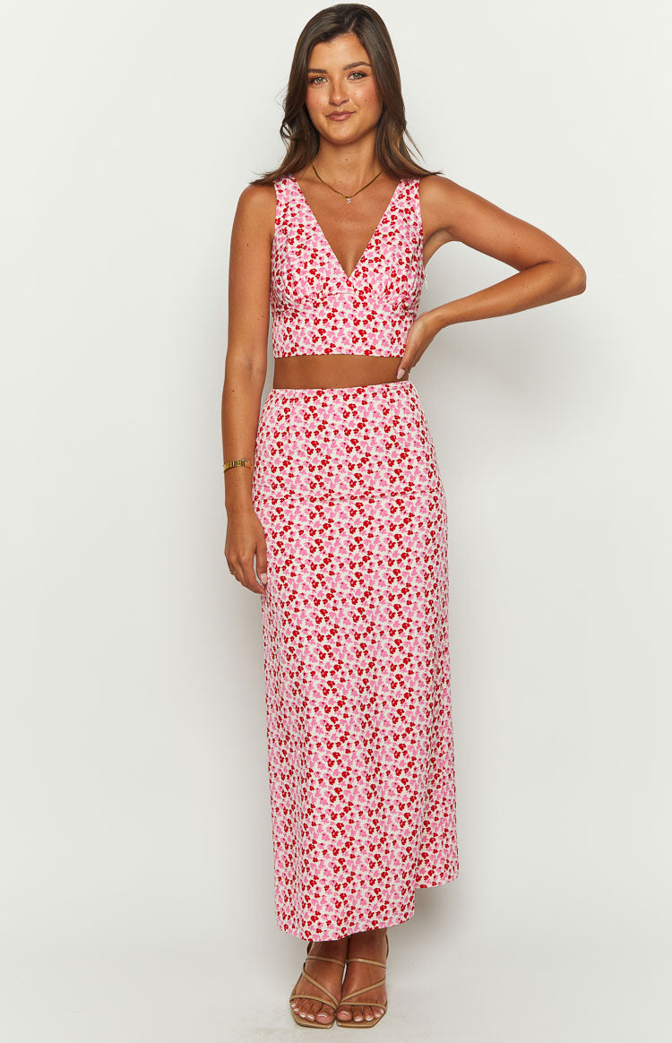 Pink and red speckled maxi skirt with a fitted high waist and flowing silhouette
