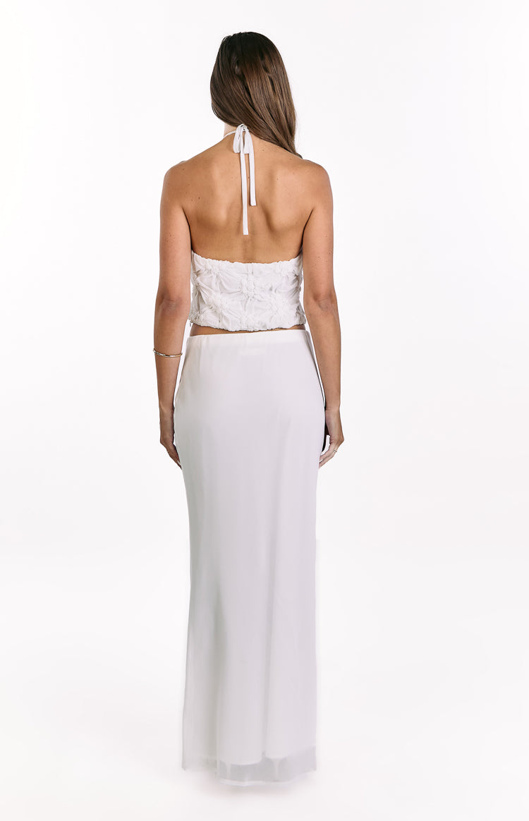 Rear view of the white textured halter top showing the tie-back halter straps and cropped hem