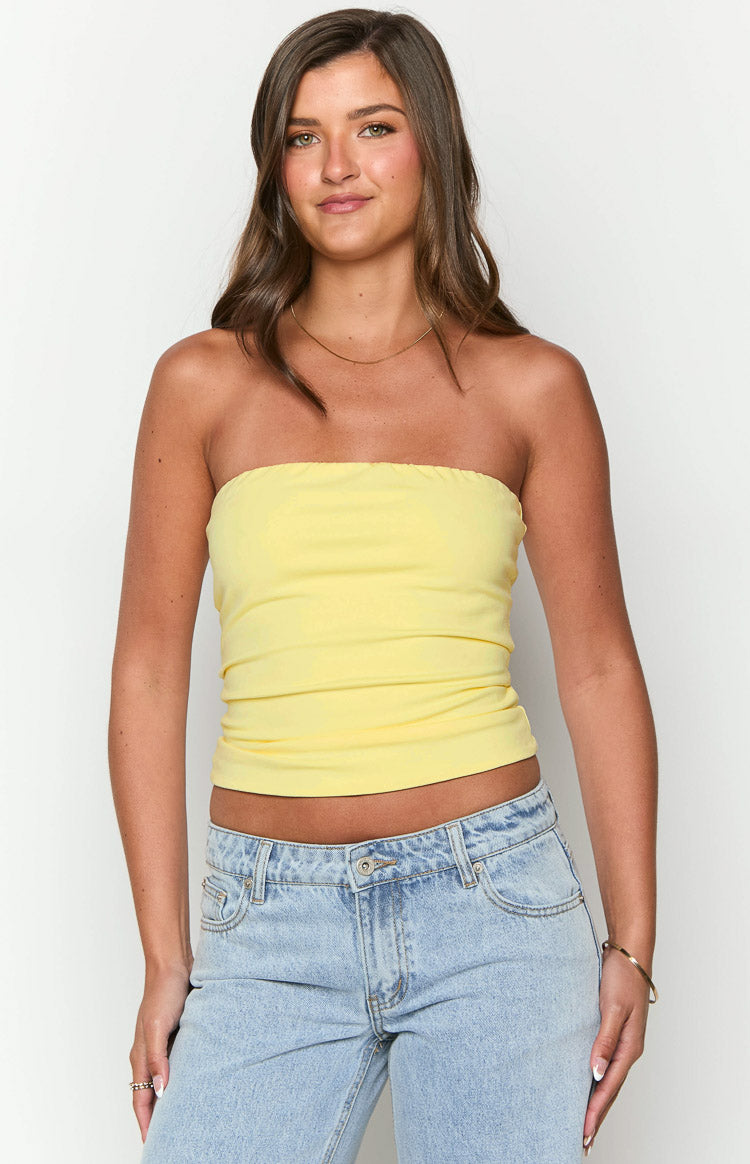 Yellow strapless tube top with a fitted, cropped silhouette and soft gathered fabric