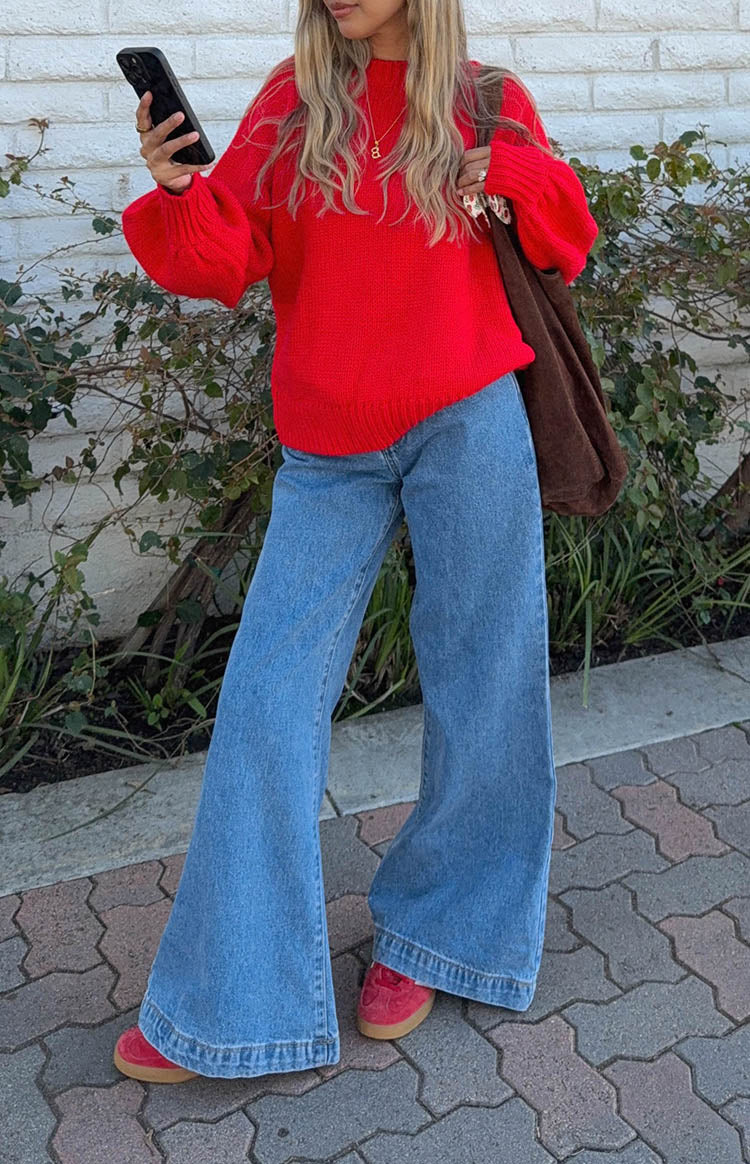 Mid wash denim flare jeans with a wide leg silhouette and a pronounced flared hem