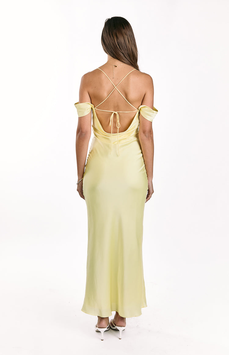 Rear view of a light yellow maxi dress with a low cowl back, criss-cross tie straps, and off-shoulder sleeves