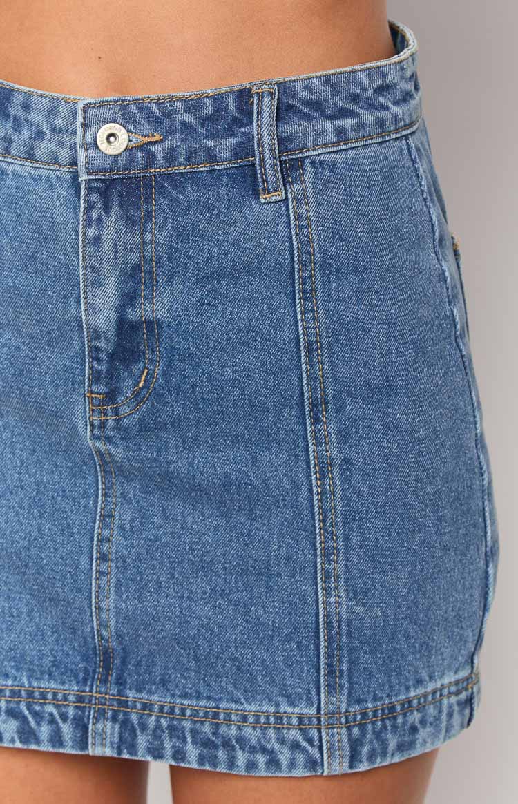 Beginning Boutique Darcy Mid Wash Denim High Waisted Mini Skirt mid wash denim high waisted mini skirt with button fly and contrast stitching