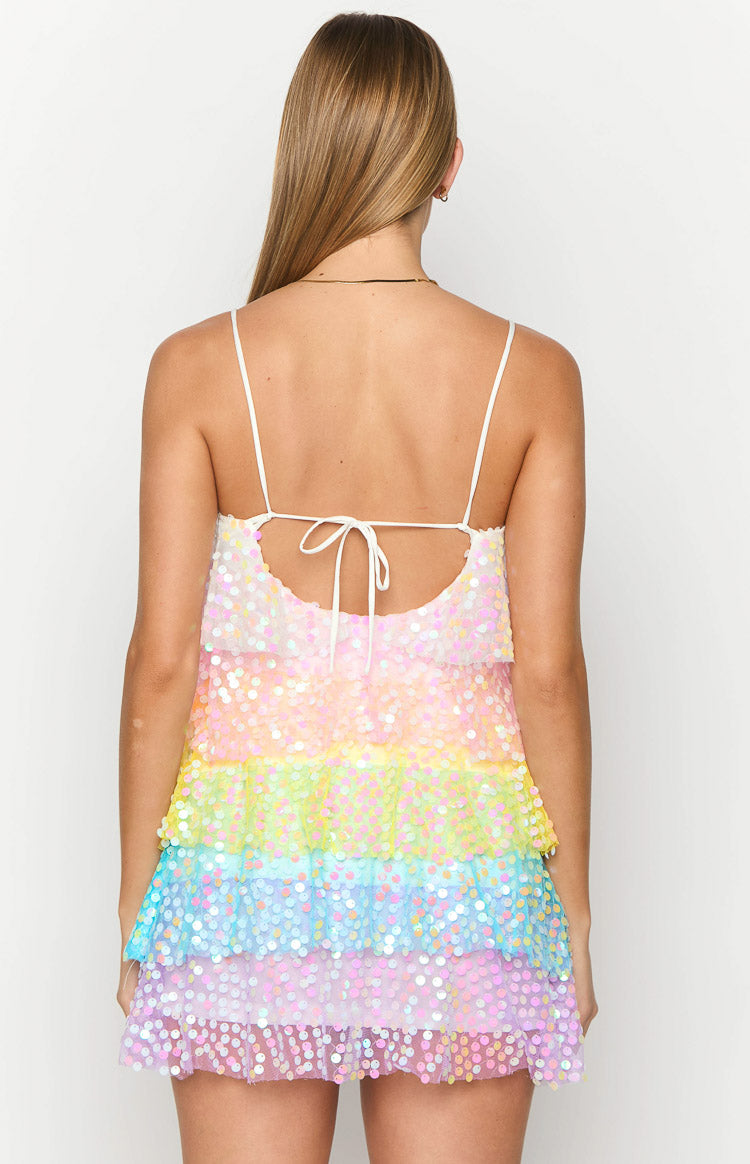 Rear view of the rainbow sequin mini dress showing thin spaghetti straps, a tie-back, and tiered skirt