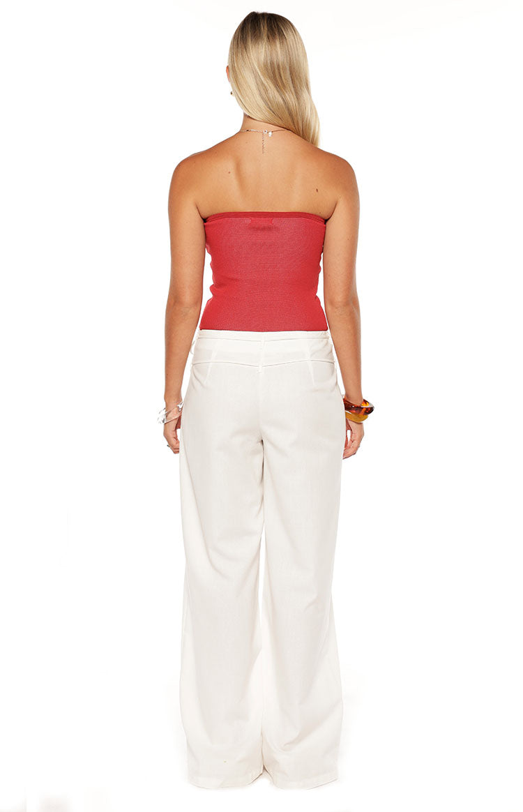 Rear view of a fitted red knit strapless tube top with a subtle ribbed texture