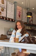 Light blue and cream striped chunky knit sweater with a relaxed off-shoulder fit