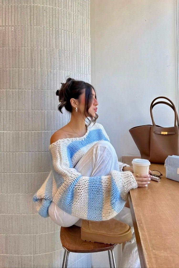 Light blue and white striped chunky knit sweater with a wide off-shoulder neckline and oversized sleeves