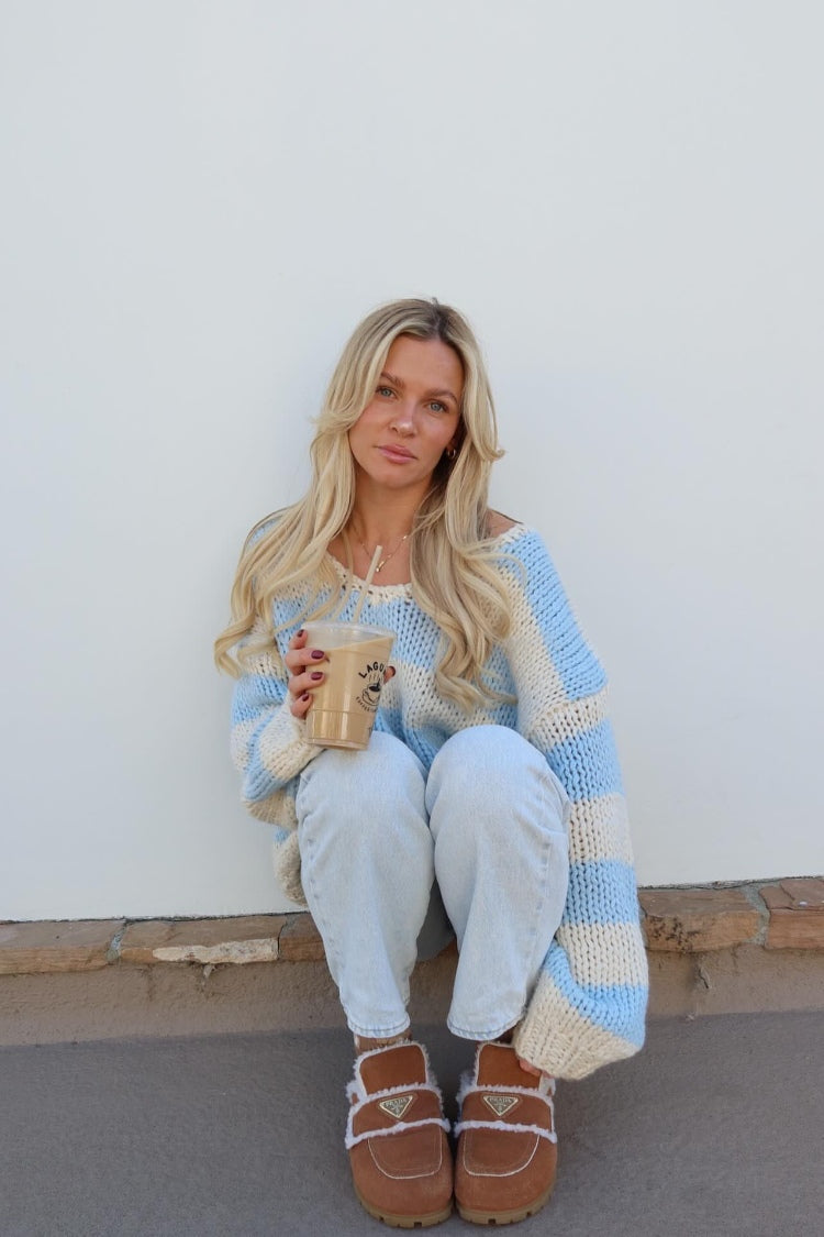 Light blue and cream striped chunky knit sweater with a wide scoop neck and relaxed oversized fit