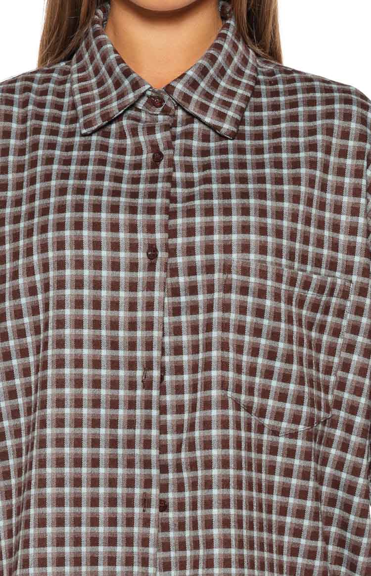 Front close-up of the brown and light blue plaid shirt, highlighting the collar, button placket, and chest pocket