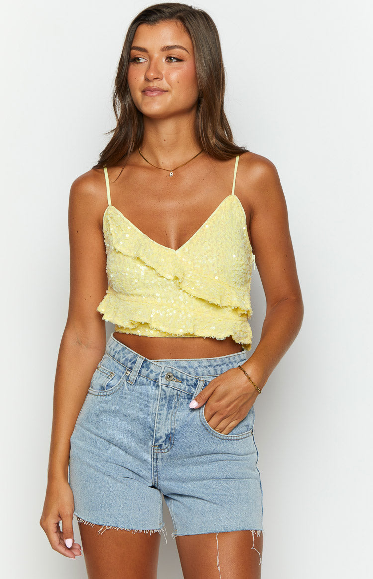 Yellow sequin crop top with a V-neck, thin spaghetti straps, and layered ruffle detailing across the front