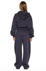 Rear view of navy barrel leg track pants with a wide elasticated waistband and relaxed, slouchy fit