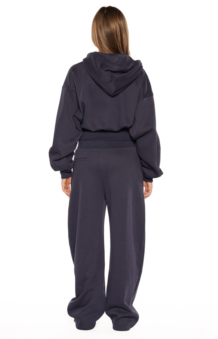 Rear view of a navy oversized cropped hoodie sweater with a hood and elasticated hem and cuffs