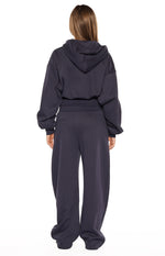 Rear view of a navy oversized cropped hoodie sweater with a hood and elasticated hem and cuffs