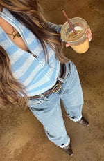Blue and white striped knit sweater with a silver full zip front partially unzipped creating a V-neck
