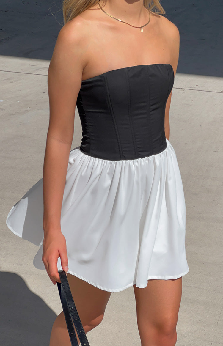 Black strapless corset bodice with vertical seams and the white gathered mini skirt