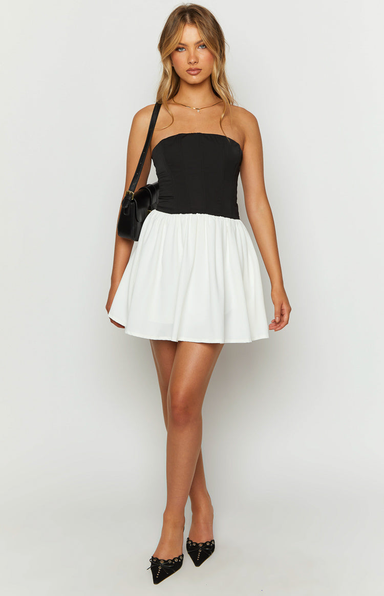 Black strapless corset top with a white gathered mini skirt