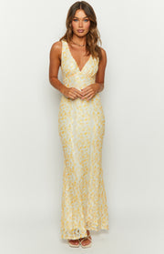 Full front view of a yellow floral lace maxi dress with a V-neckline and fitted silhouette
