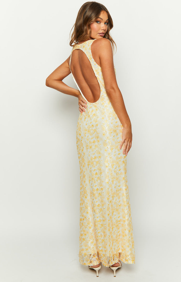 Side and rear view of a yellow floral lace maxi dress with a deep rounded cutout back