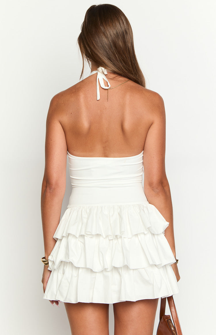 Rear view of a white mini dress with a halter neck tie and tiered ruffle skirt