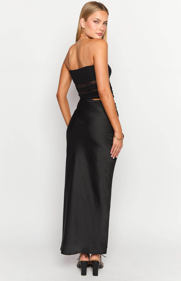 Rear view of a black strapless maxi dress featuring a bandeau bodice with sheer mesh panels and a flowing satin skirt