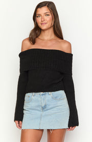 Black off-shoulder knit sweater with a wide ribbed fold-over neckline and long sleeves