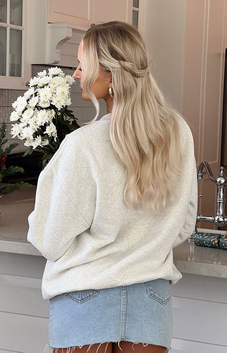 Rear view of an oat marle crew neck sweater showing the relaxed fit and dropped shoulders