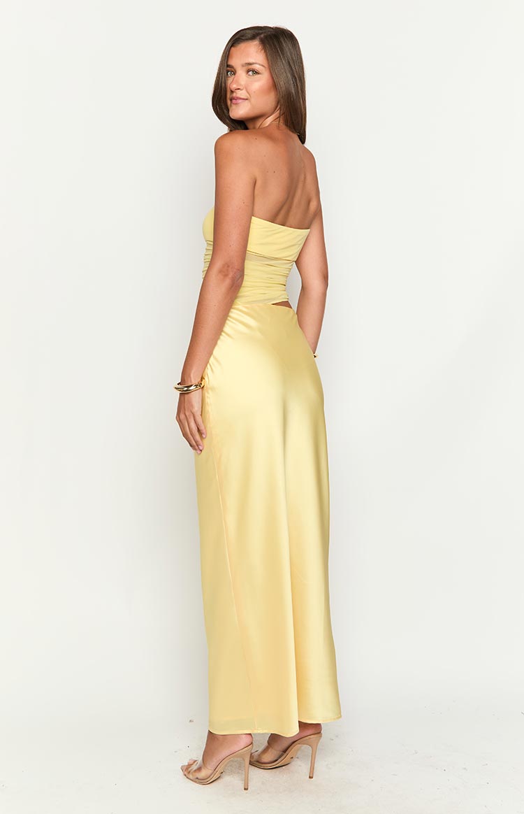 Rear view of a yellow strapless satin maxi dress with a ruched bodice and back waist cutout