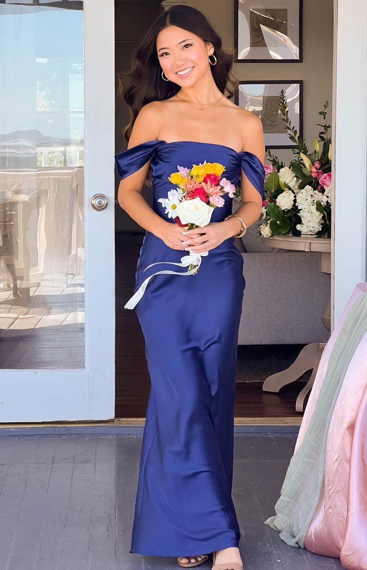Beginning Boutique Ella Navy Off Shoulder Formal Maxi Dress navy satin off shoulder maxi dress with ruched sleeves and a fitted bodice