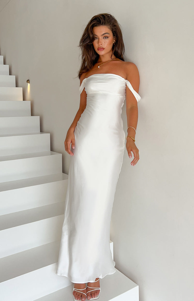 Full length view of a white off-shoulder satin formal dress with a fitted bodice and flowing maxi skirt