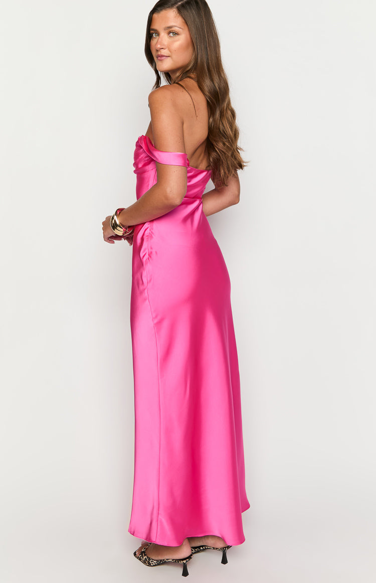 Side view of the hot pink satin off-shoulder formal dress with draped neckline and long flowing skirt