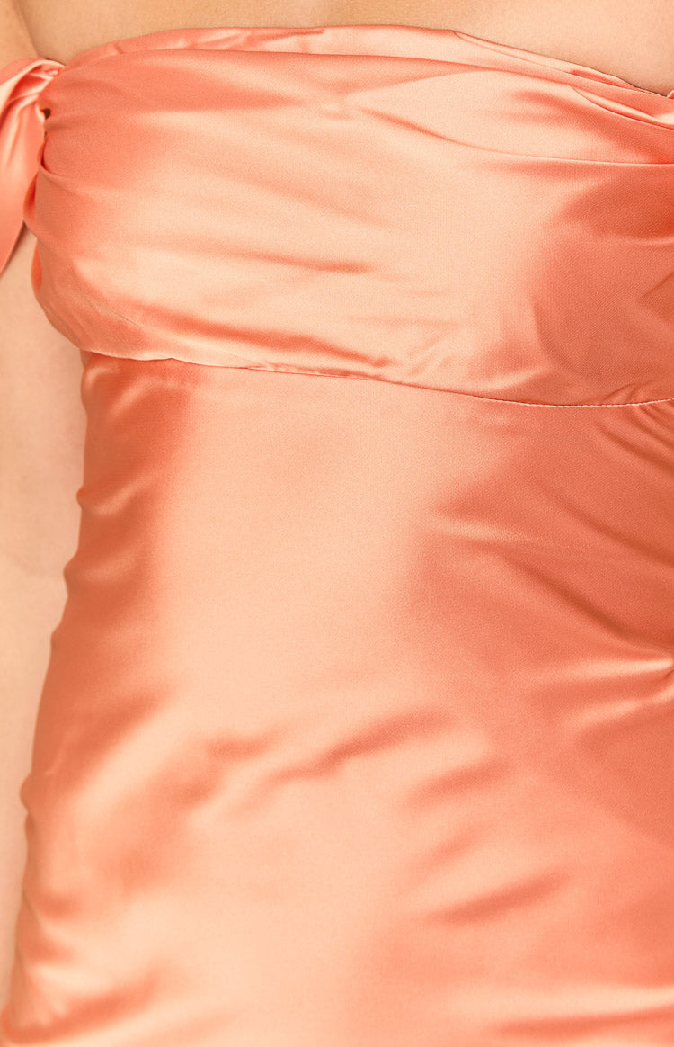 Close-up of the orange satin off-shoulder neckline with draped detail and fitted bodice