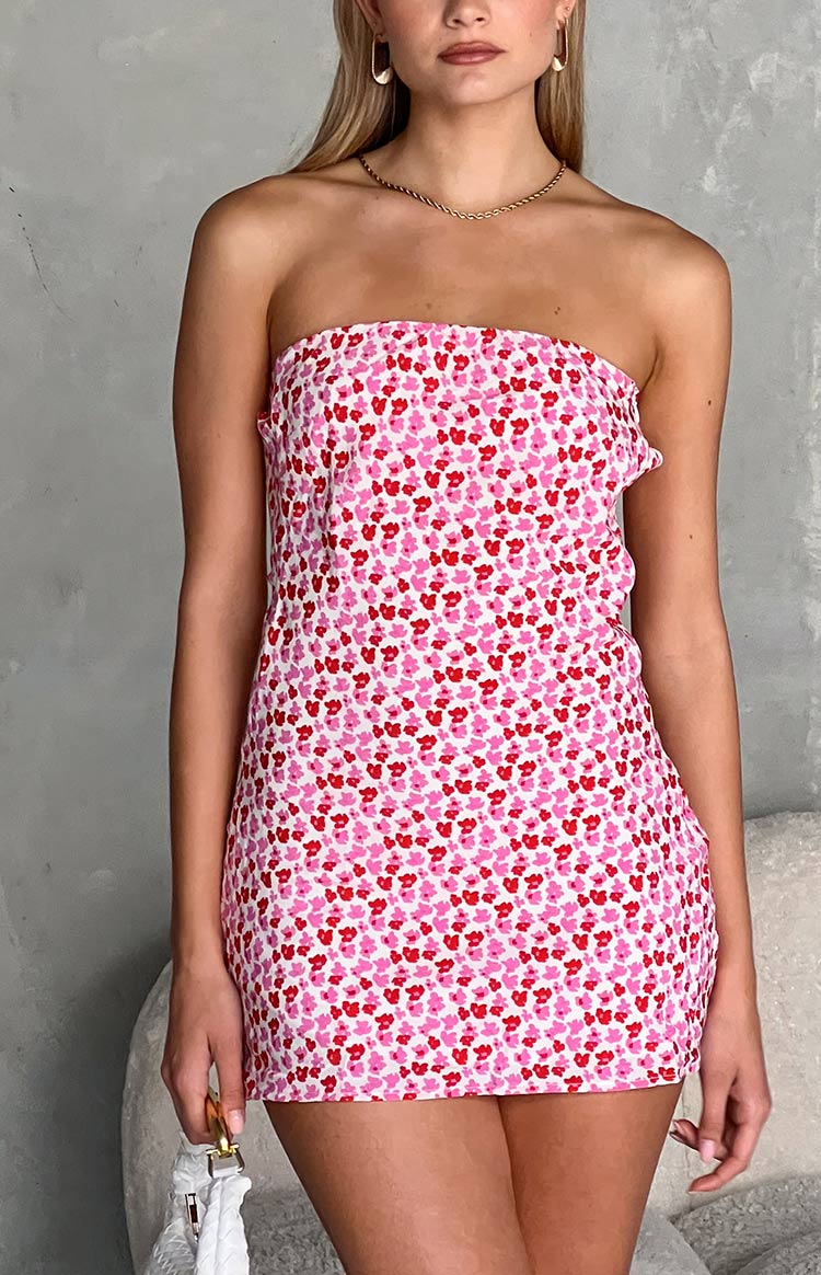 Front view of a white strapless mini dress with an all-over pink and red speckled pattern and a fitted silhouette
