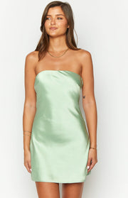 Front view of a sage green strapless mini dress with a straight neckline in smooth satin fabric