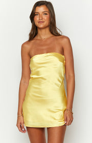 Smooth yellow satin strapless mini dress with a straight neckline and fitted bodice