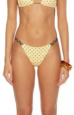 Front view of yellow polka dot bikini bottoms with brown contrast straps perfect for a Summer vacation